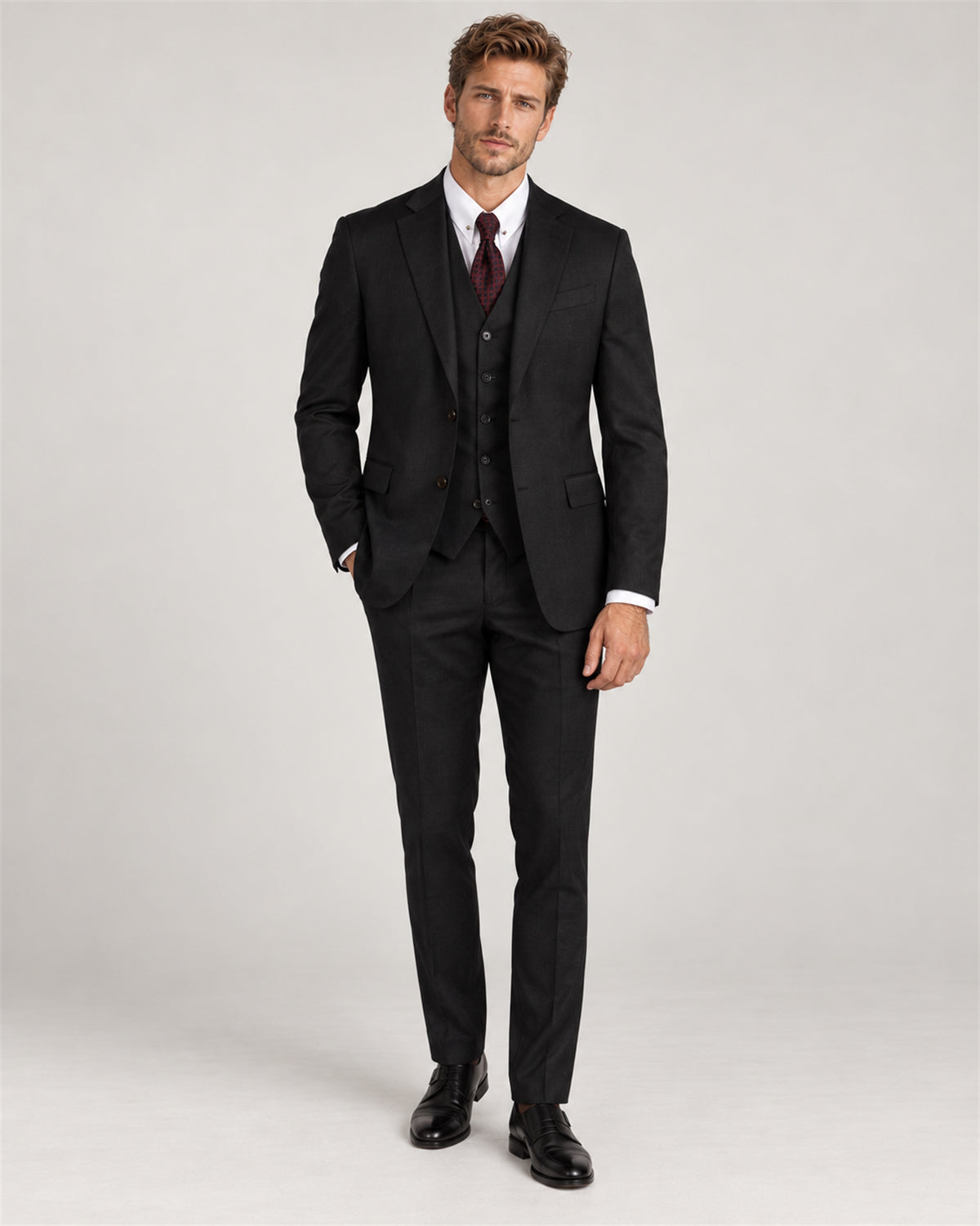 Dark grey tailored-fit three-piece wool suit – full-length view on model