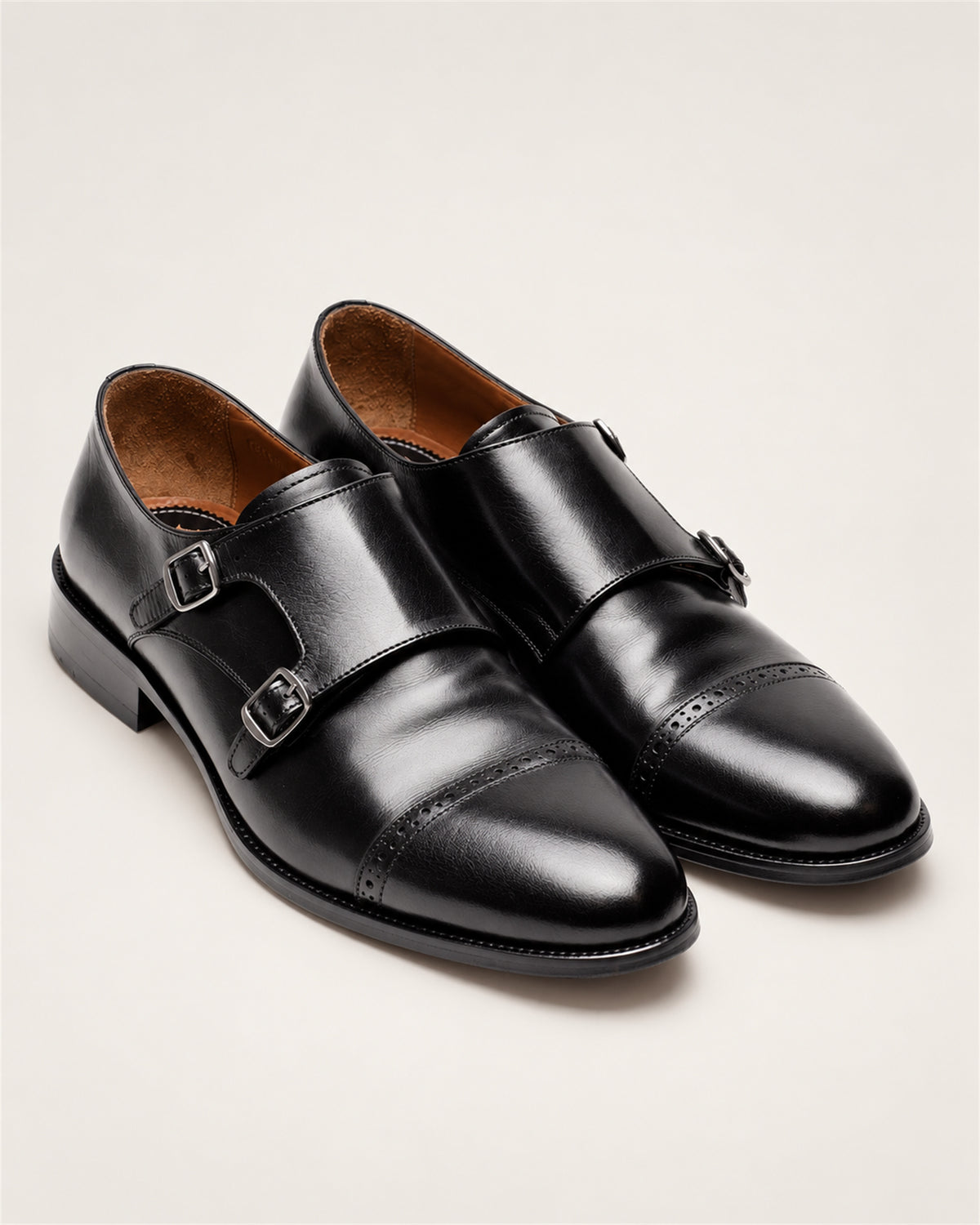 Black buffalo leather double monk strap shoes – pair of shoes at an angle