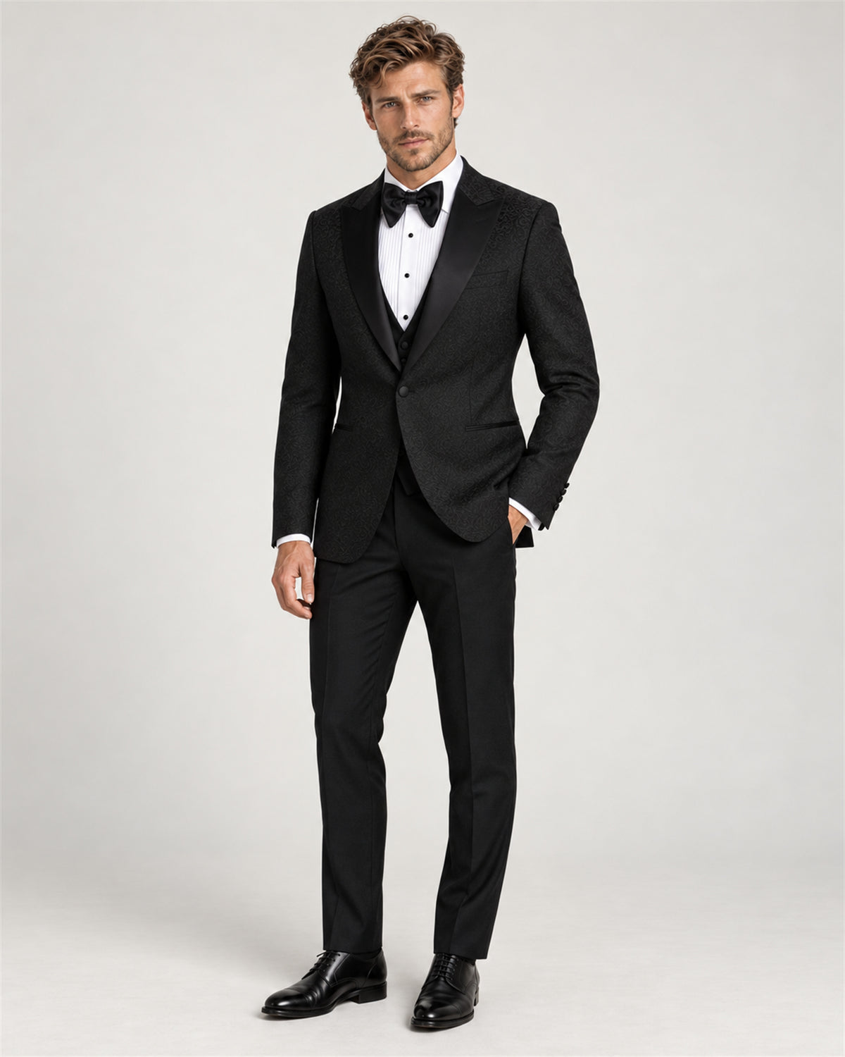 Black three-piece slim-fit tuxedo with a shawl collar – full-length view on model