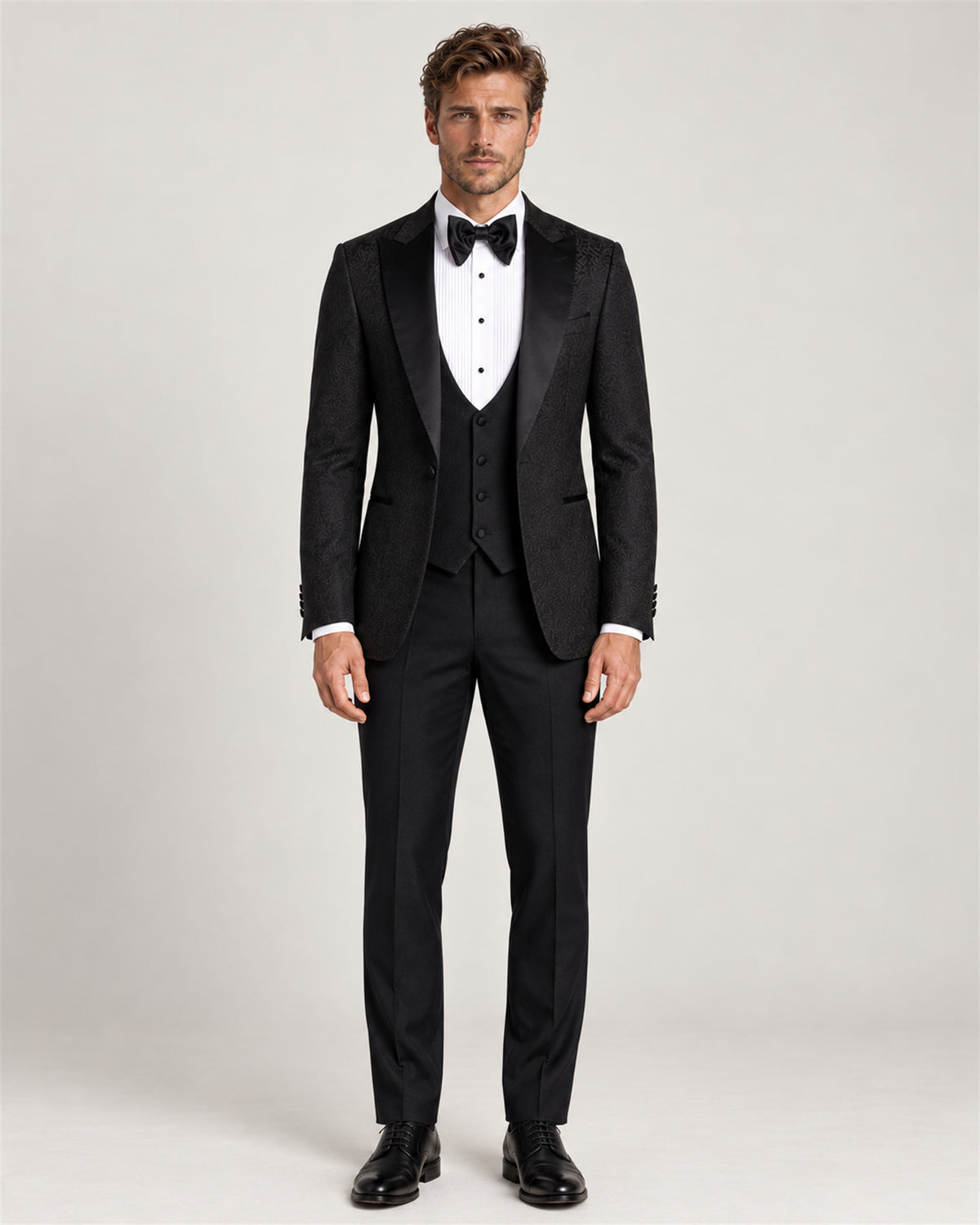 Black three-piece slim-fit tuxedo with a shawl collar – full-length view on model