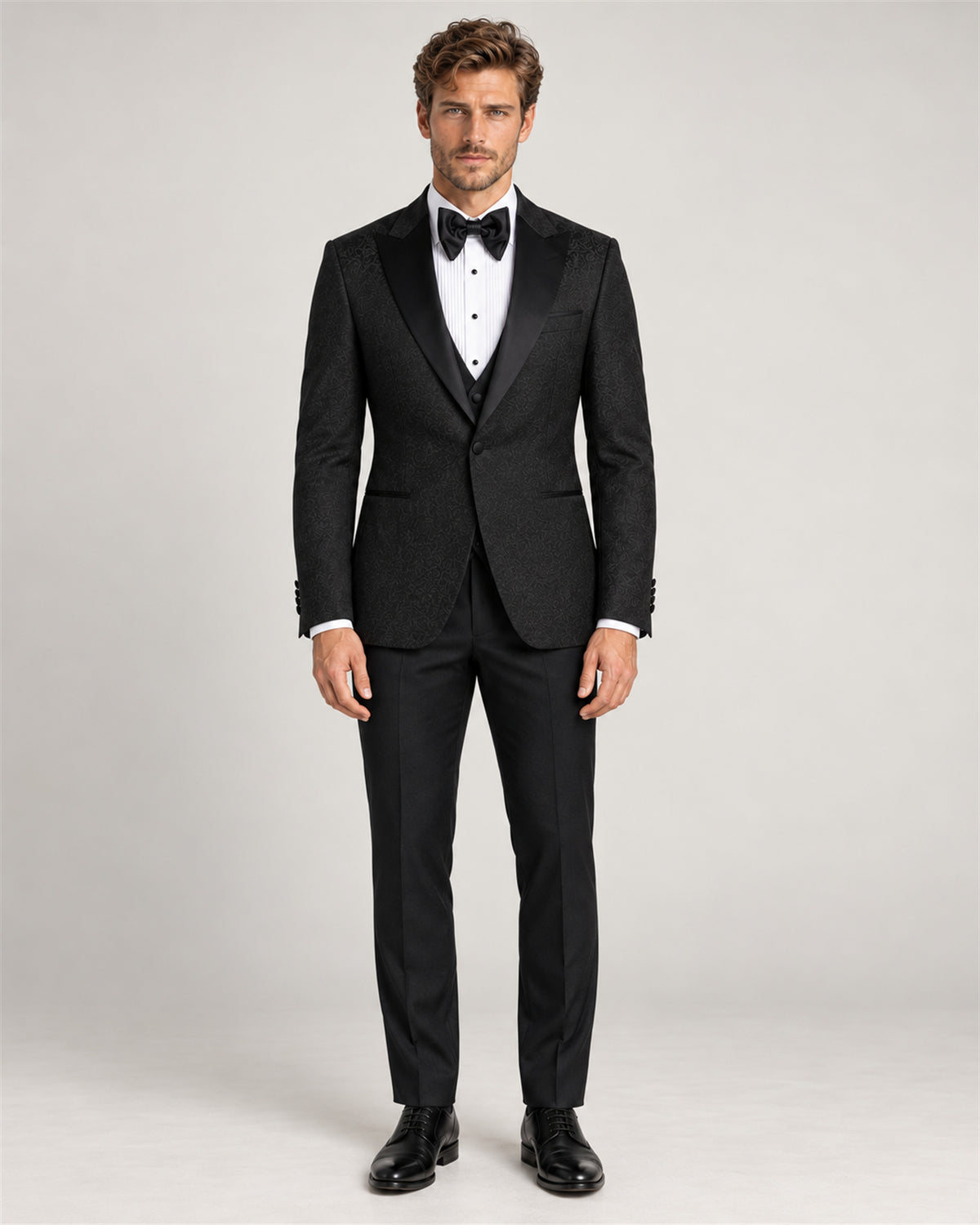 Black three-piece slim-fit tuxedo with a shawl collar – full-length view on model